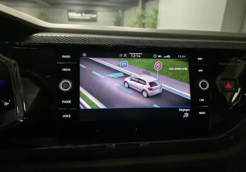 Écran tactile du tableau de bord affichant la fonction IQ.DRIVE avec une Polo grise vue de dessus en simulation.
