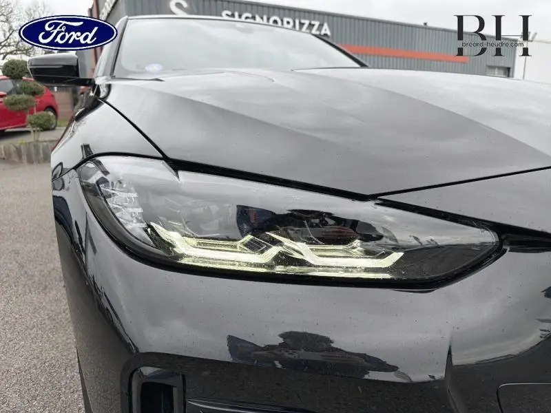 Gros plan sur le phare avant gauche d’une BMW Série 4 Gran Coupe 420iA Saphirschwarz métallisé avec éclairage LED distinctif.