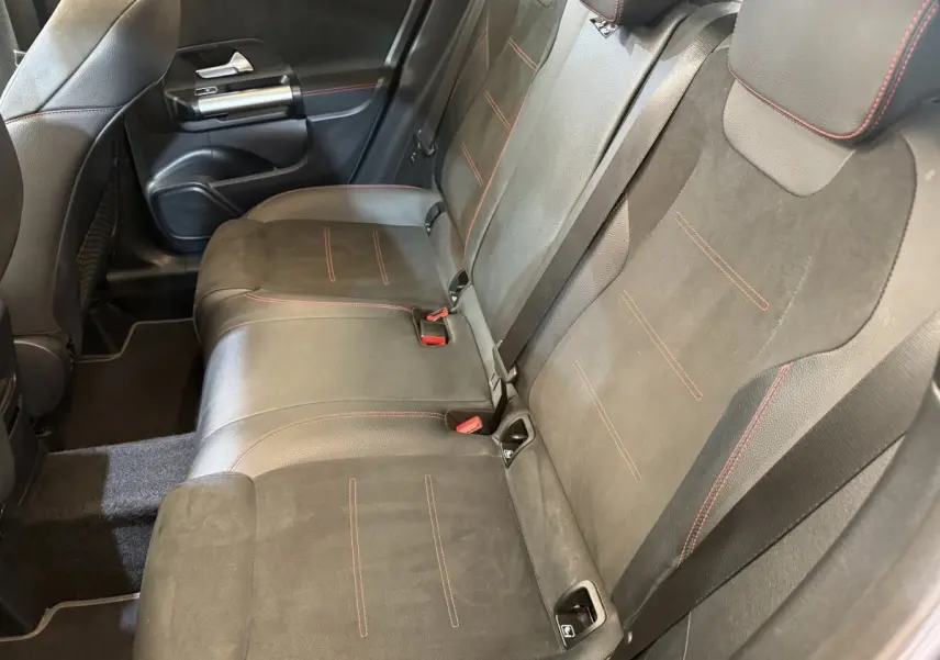 Vue intérieure côté droit montrant la banquette arrière en cuir noir avec surpiqûres rouges du Mercedes GLA 250 e AMG Line 2023.