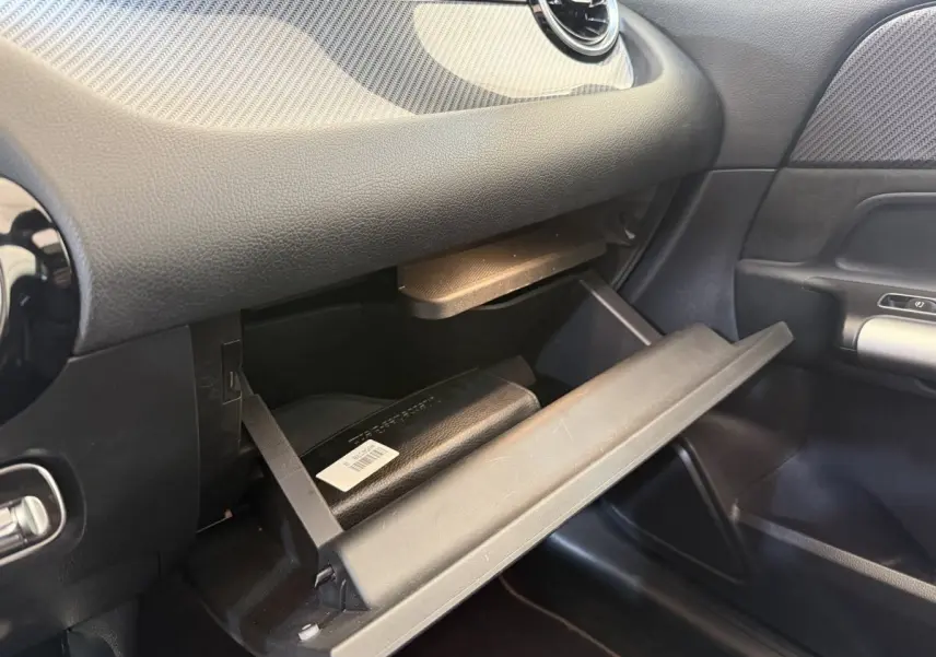Gros plan sur la boîte à gants ouverte côté passager du Mercedes GLA 250 e AMG Line gris clair 2023.