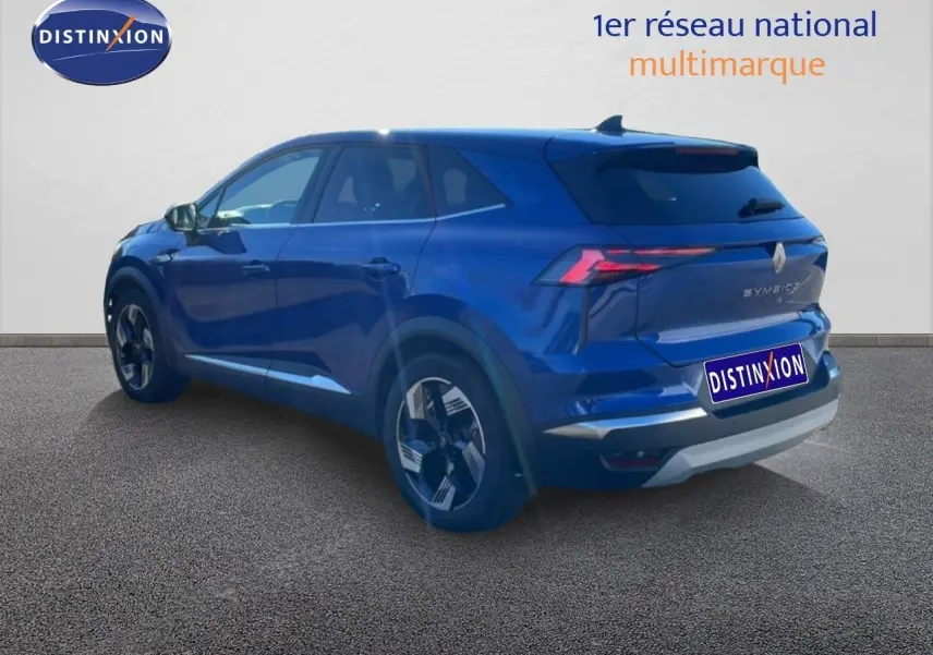 Renault Symbioz 2025 bleu Iron Metal en 3/4 arrière droit, SUV hybride avec feux LED et jantes bi-ton.
