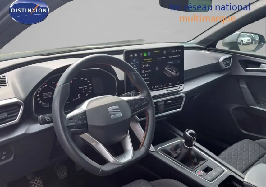 Intérieur de la SEAT LEON ST 2025, vue du poste de conduite avec volant multifonction et écran tactile central.