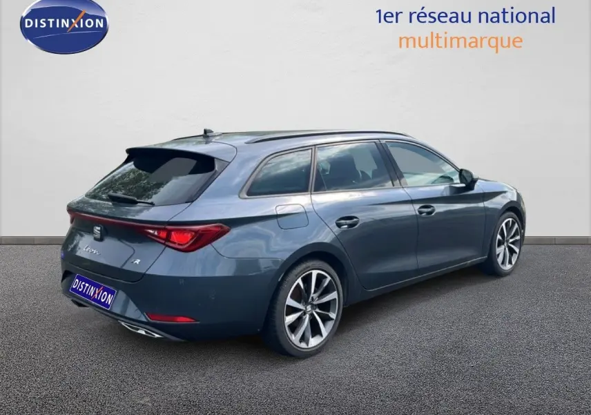 SEAT Leon ST gris magnétique métal vue 3/4 arrière droit, break compact avec jantes alliage et feux LED distinctifs.