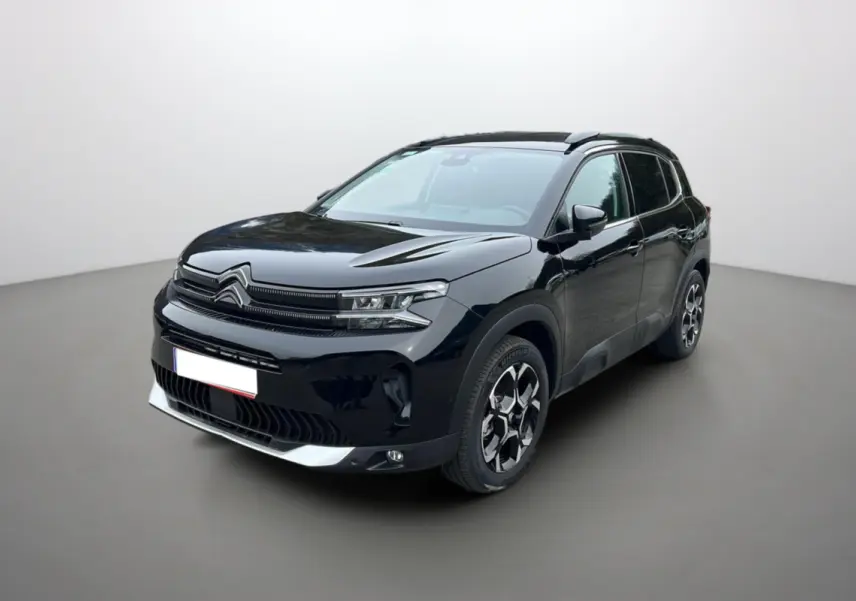 Citroën C5 Aircross Hybrid noir en 3/4 avant droit, avec barres de toit et jantes alu 18 pouces visibles.