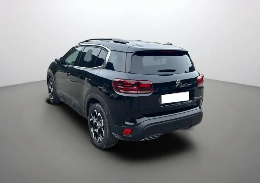 Citroën C5 Aircross Hybrid noir vue 3/4 arrière droit, avec barres de toit et vitres surteintées.