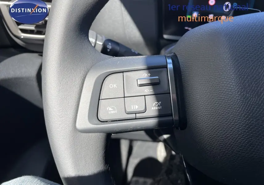 Gros plan sur les commandes de régulateur de vitesse au volant d’une Citroën C4 hybride 2026, intérieur noir.