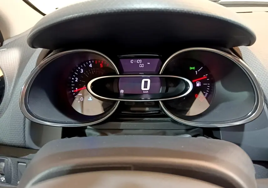 Vue rapprochée du tableau de bord numérique de la Renault Clio blanche, affichant la vitesse à 0 km/h.