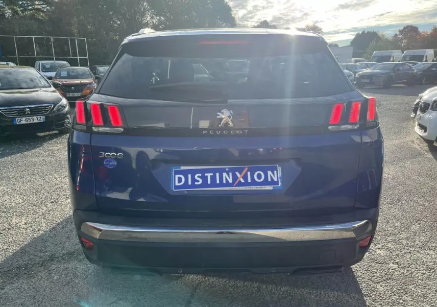 Vue arrière d'un Peugeot 3008 bleu magnétique avec feux arrière à trois griffes et logo lion central.