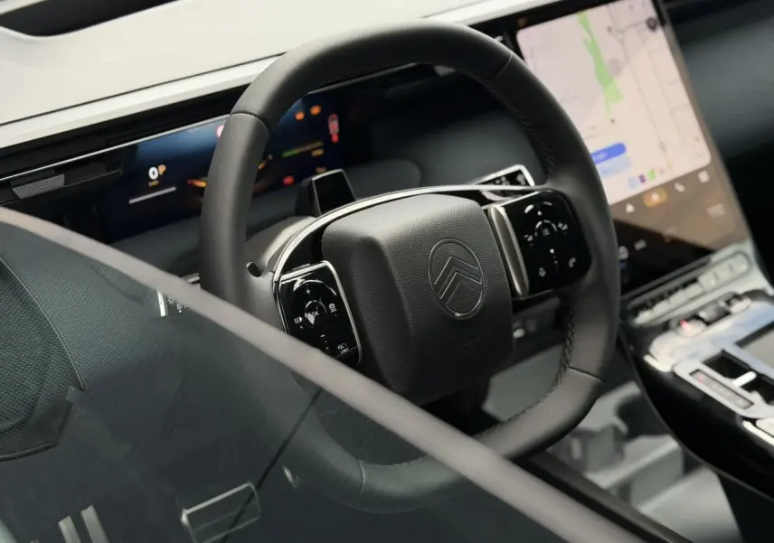 Vue rapprochée du volant noir multifonctions et de l’écran tactile vertical du tableau de bord du Citroën C5 Aircross 2026.