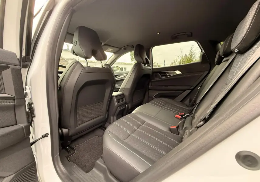 Vue intérieure côté droit sur la banquette arrière en tissu noir du Renault Austral E-Tech 200 blanc nacré avec toit noir.