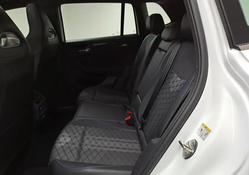 Vue intérieure côté droit sur les sièges arrière en tissu et cuir noir du Volkswagen Tiguan blanc pur 2025 R-Line Edition.