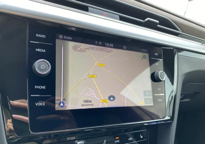 Écran tactile 8 pouces du système de navigation dans l'habitacle noir du Volkswagen Arteon blanc pur.