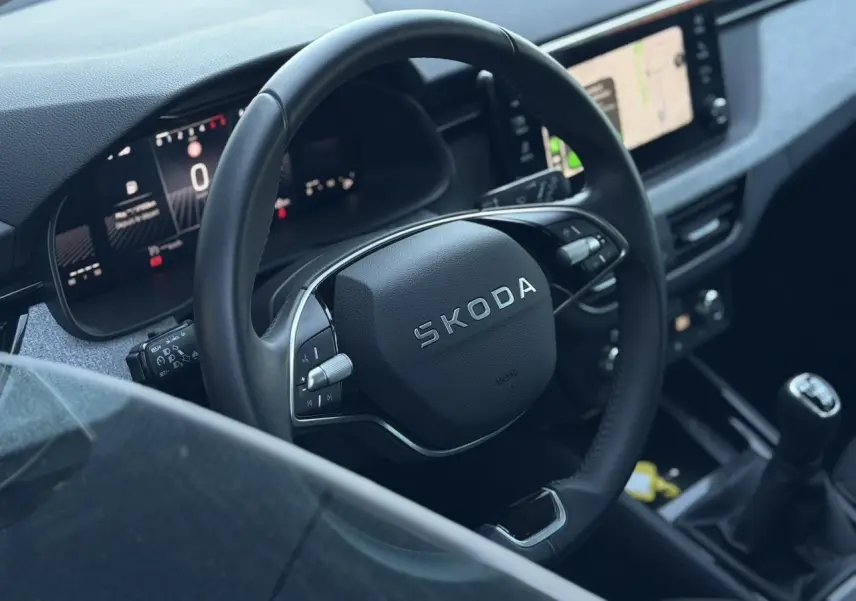 Vue rapprochée du volant en cuir multifonctions et du tableau de bord numérique de la Skoda Scala TSI 116 blanche.