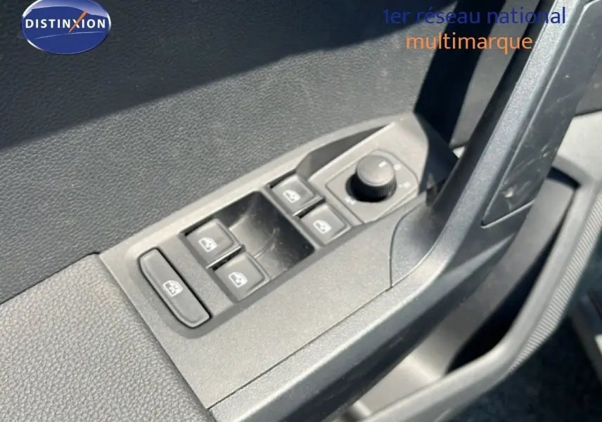 Gros plan sur les commandes de lève-vitres et réglage des rétroviseurs côté conducteur du SEAT Arona gris Magnetic Metal.