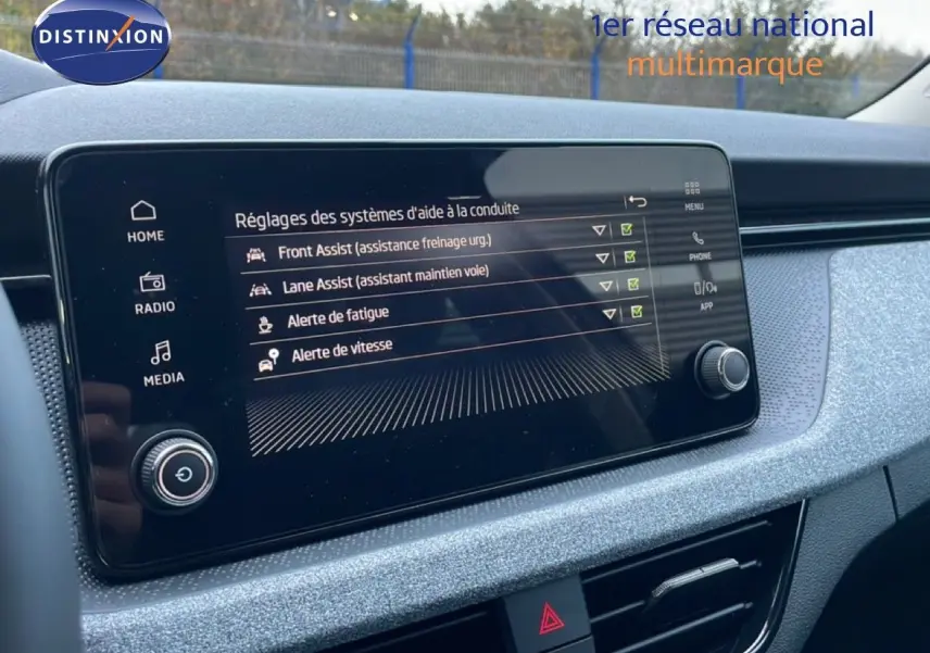 Écran tactile central affichant les réglages d'aide à la conduite dans l'habitacle gris clair du Skoda Kamiq 2025.