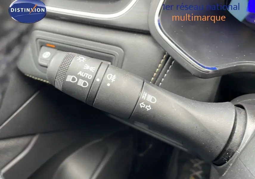 Gros plan sur la commande des phares et clignotants dans l’habitacle noir du Renault Symbioz bleu Iron Metal.