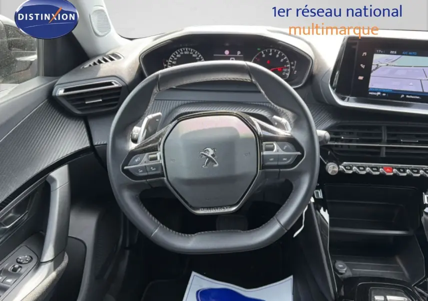 Vue intérieure centrée sur le volant cuir noir du Peugeot 2008 2022 avec tableau de bord et écran tactile.