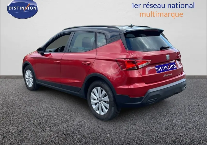 SEAT Arona rouge désir métal avec toit noir, vue 3/4 arrière côté gauche, sur fond neutre extérieur.