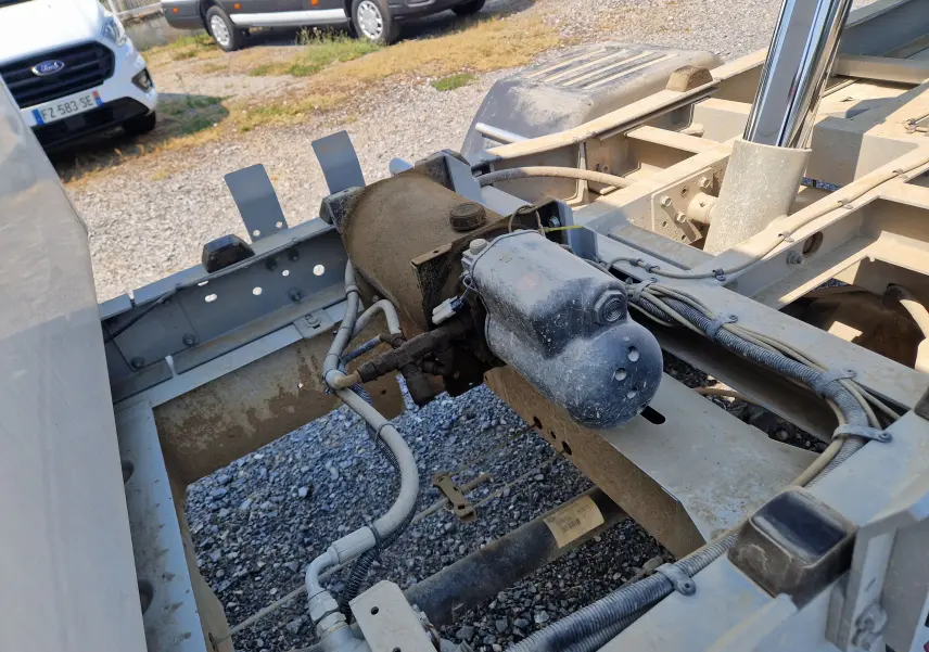 Détail du châssis arrière du Renault Master blanc, montrant la benne aluminium et les composants mécaniques sous la cabine.