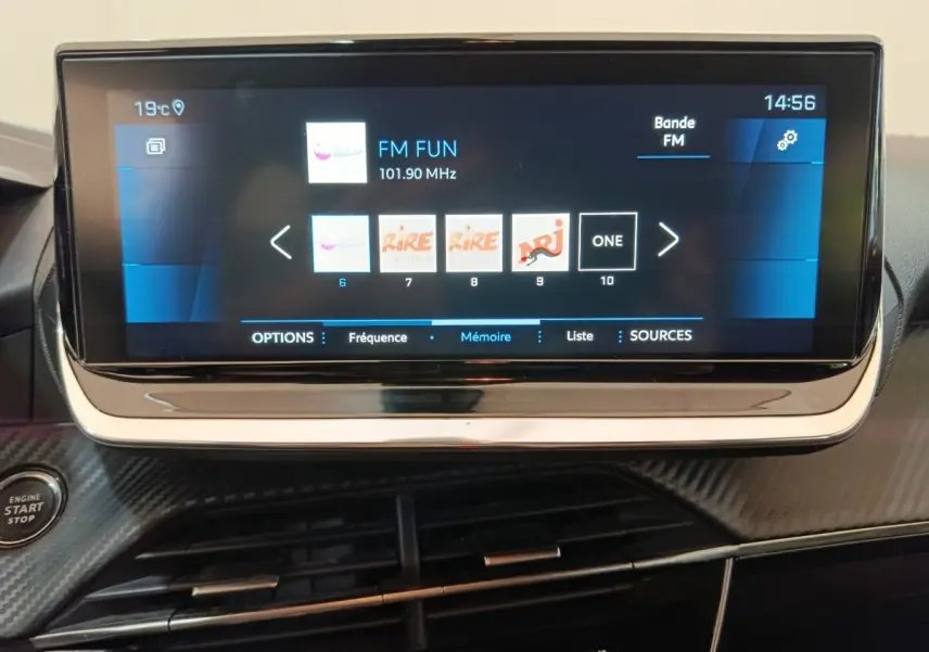 Écran tactile central de 10 pouces affichant les stations radio dans l'habitacle d'une Peugeot 208 blanche.