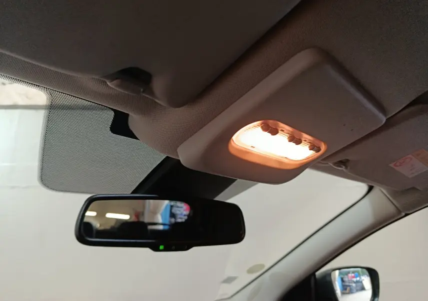 Vue intérieure du plafonnier allumé et du rétroviseur central d’un Nissan Qashqai gris clair 2019.