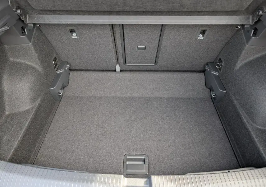 Coffre spacieux vu de dessus du Volkswagen T-Roc gris 2025 avec revêtement intérieur gris foncé.