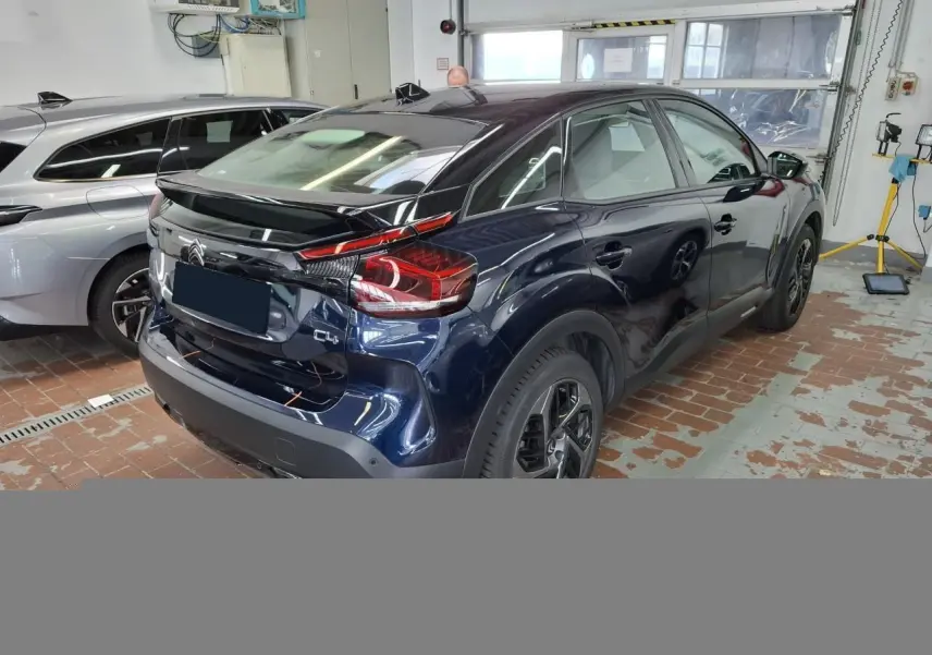 Vue intérieure côté conducteur de la Citroën C4 2024 avec tableau de bord noir et écran tactile GPS 10 pouces.