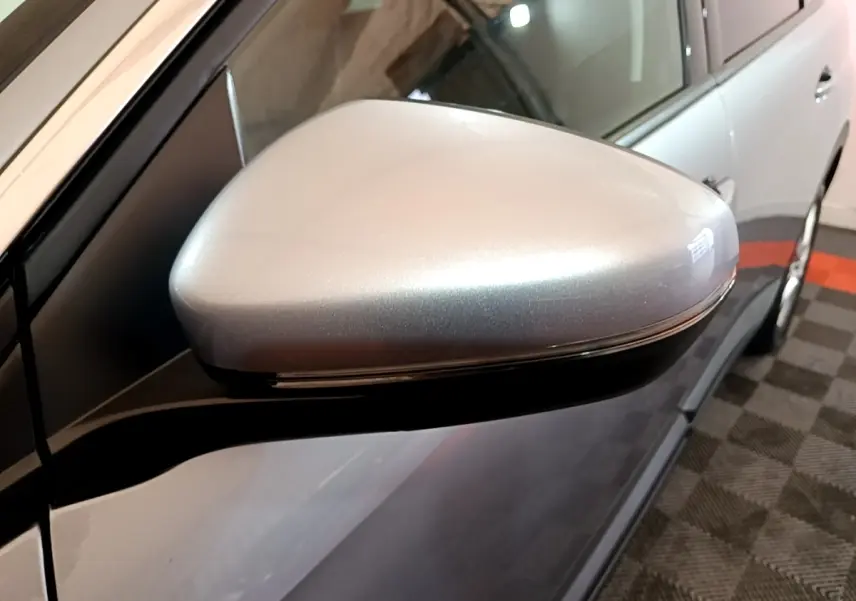 Gros plan sur le rétroviseur droit gris clair du Peugeot 5008 gris foncé, vue latérale en intérieur.
