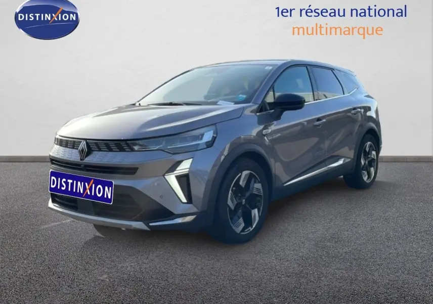 Renault Symbioz gris cassiopée métal en 3/4 avant droit, SUV hybride avec signature lumineuse distinctive.