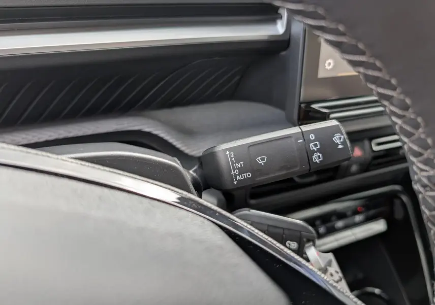 Gros plan sur la commande d’essuie-glace noire côté gauche du tableau de bord gris et noir du Citroën C3 Aircross 2026.