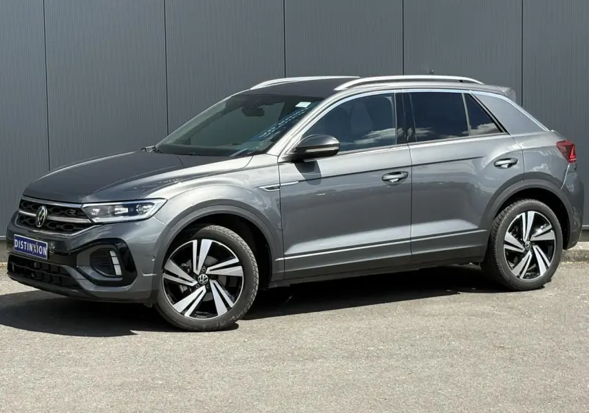 Volkswagen T-Roc 2025 gris Indium en profil droit, avec jantes alliage 18" Nevada et calandre R-Line.