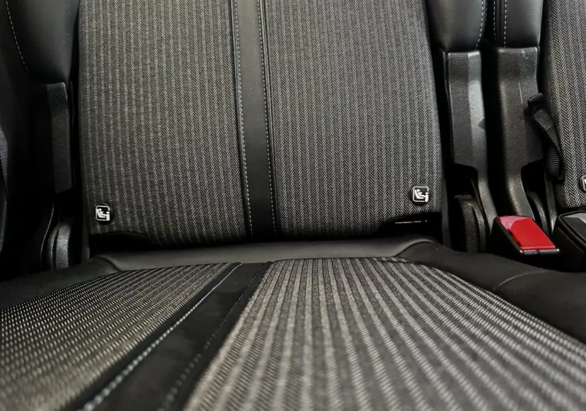 Gros plan sur la banquette arrière individuelle noire et grise du Peugeot 5008 2022 avec ceinture rouge visible.