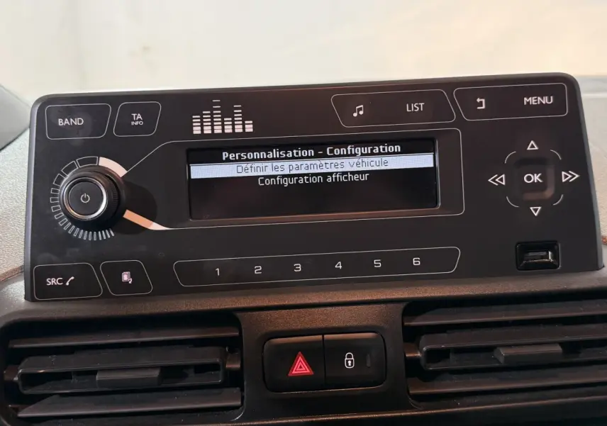 Vue rapprochée du tableau de bord du Peugeot Rifter blanc 2019, affichant l'écran de configuration du système multimédia.