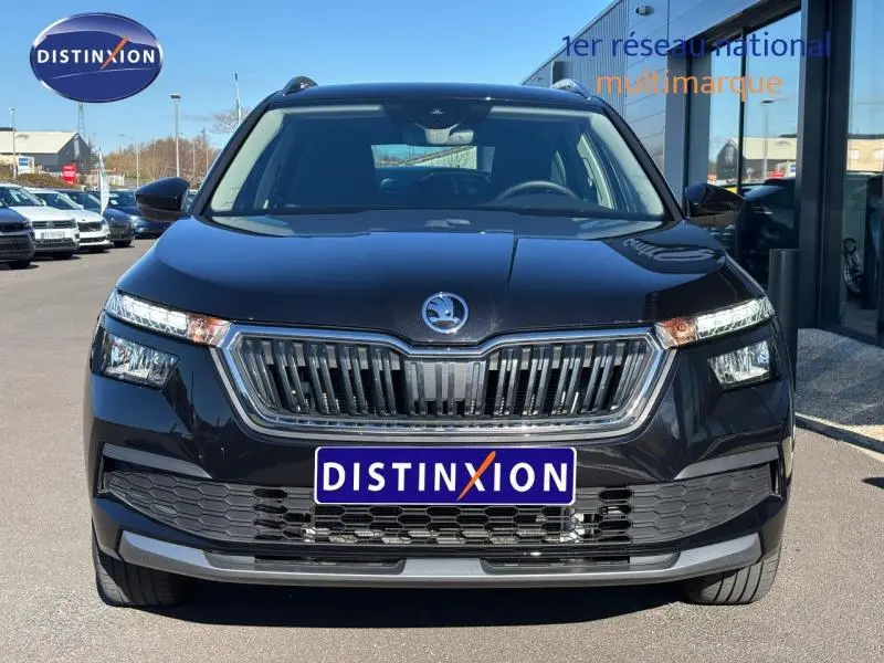 Vue frontale d'un Skoda Kamiq 1.5 TSI Ambition noir Magic nacré, avec calandre chromée et phares LED distinctifs.