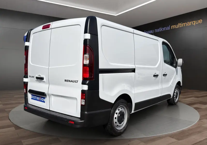 Vue 3/4 arrière droite d’un Renault Trafic Fourgon blanc, avec portes arrière battantes et jantes acier.
