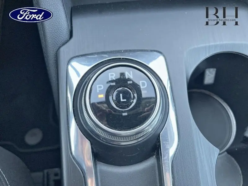 Gros plan sur la molette de sélection de la boîte automatique du Ford Kuga 2023, finition Titanium, avec éclairage orange sur "P".