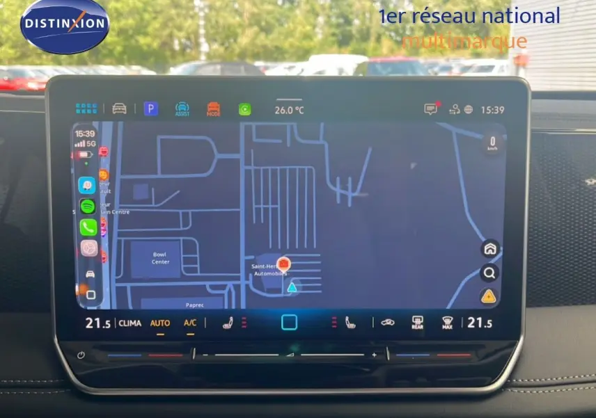 Vue rapprochée de l’écran tactile central du Volkswagen Tiguan noir Grenadilla, affichant la navigation et la climatisation.