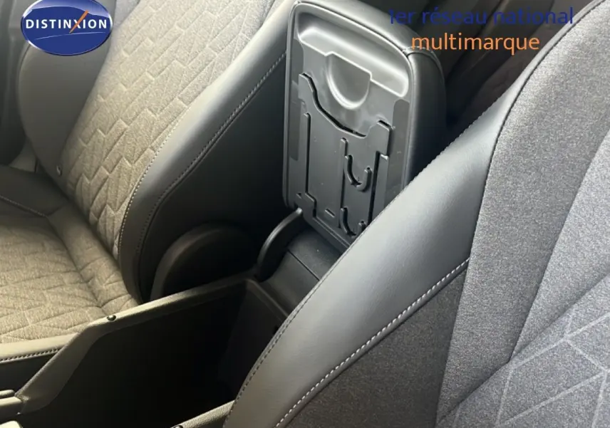 Détail de l'accoudoir central ouvert entre les sièges avant en tissu et cuir gris du Volkswagen Tiguan noir Grenadilla.