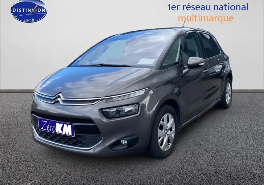 Citroën C4 Picasso gris vue 3/4 avant droit sur fond neutre avec phares et calandre distinctifs.