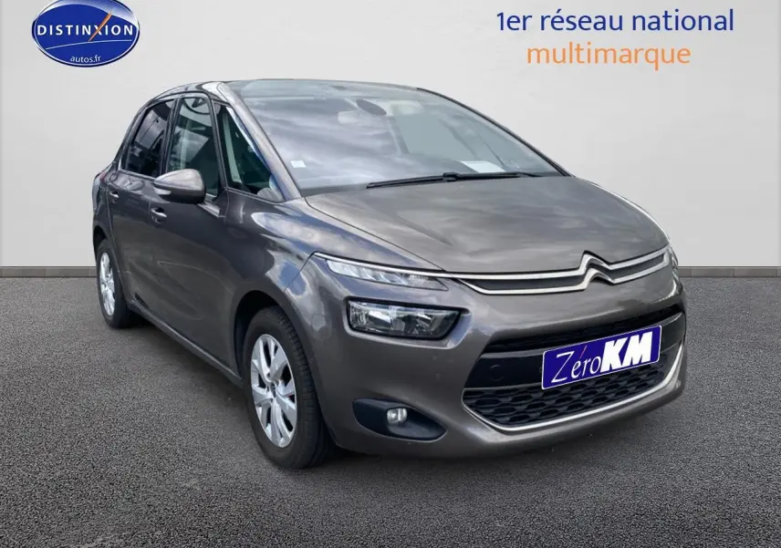 Citroën C4 Picasso gris vue 3/4 avant droit avec phares LED et jantes alu sur fond neutre.