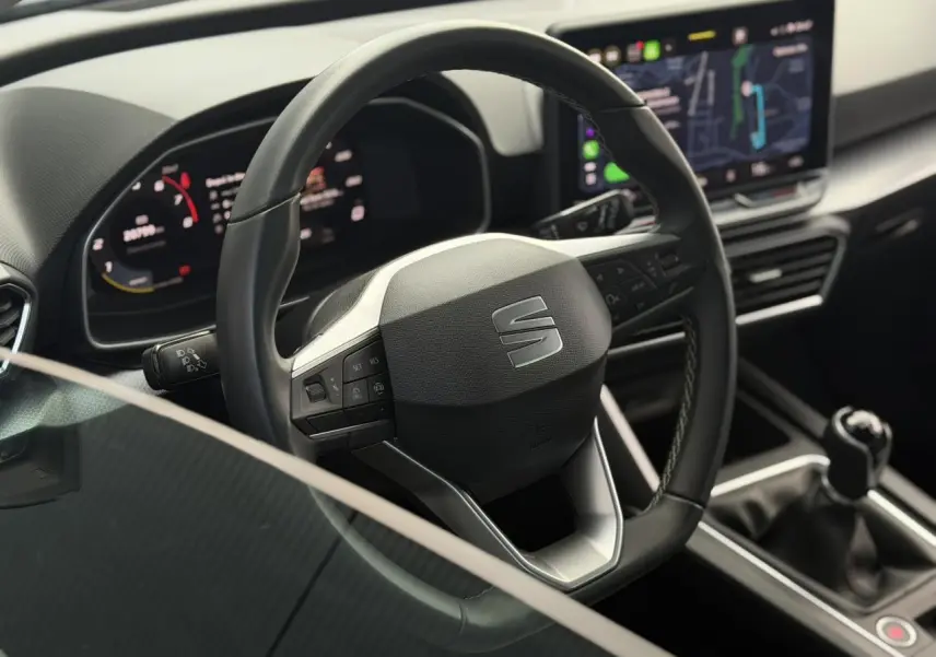 Vue rapprochée du volant cuir multifonction et levier de vitesses manuelle dans l’habitacle moderne d’une SEAT LEON ST 2025.