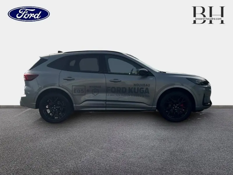 Vue de profil côté gauche du Ford Kuga gris Solar métallisé avec jantes noires et marquages publicitaires sur la porte.