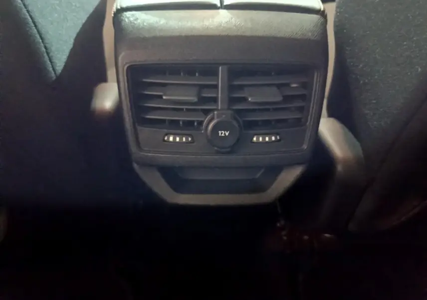 Vue rapprochée des aérateurs arrière et prise 12V noirs du Peugeot 3008 gris clair, version Puretech 130 S&S Active Business.