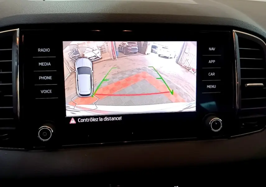 Écran tactile central du Skoda Karoq 2022 affichant la caméra de recul avec guidage de stationnement.