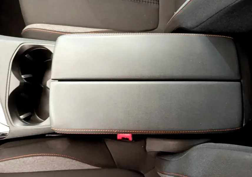 Vue plongeante sur l'accoudoir central noir avec surpiqûres rouges du Peugeot 3008 Puretech 130 S&S Active 2020.