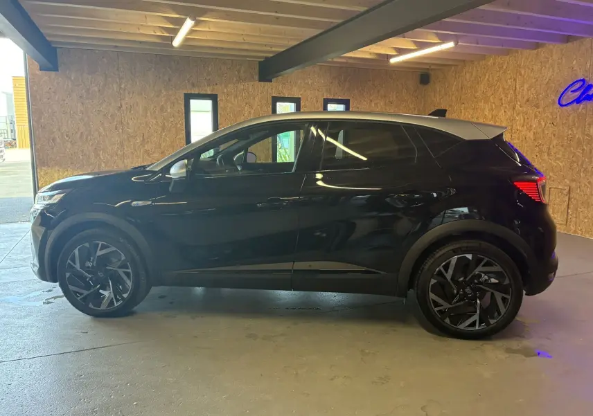 Profil droit du Renault Captur E-Tech Full Hybrid 145ch Esprit Alpine noir étoile avec toit gris en intérieur.