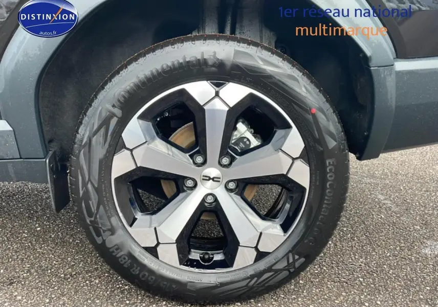 Gros plan sur la jante diamantée 18 pouces noire et argent du Dacia Bigster noir, côté arrière droit.