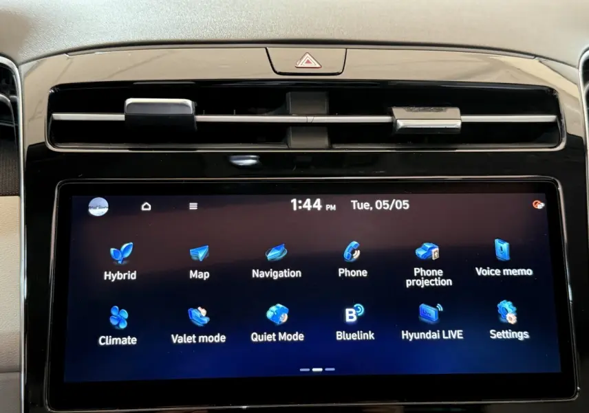 Gros plan sur l’écran tactile central du Hyundai Tucson gris foncé, affichant les options de navigation et connectivité.