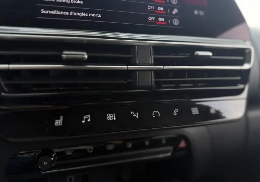 Détail de la console centrale noire du Citroën C5 Aircross 2025 avec commandes tactiles et aérateurs horizontaux.