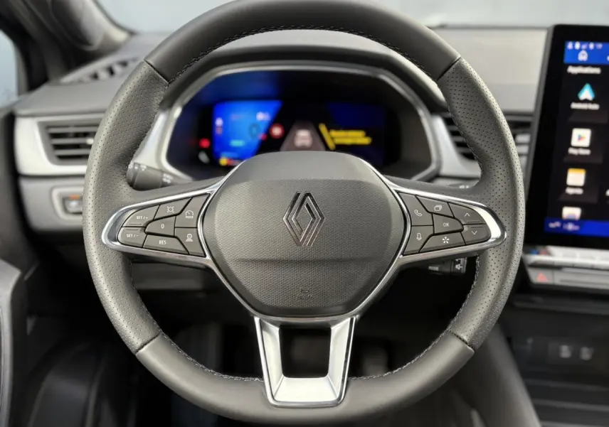 Volant multifonction en cuir noir avec logo Renault, tableau de bord numérique et écran tactile latéral dans un Renault SYMBIOZ 2025.